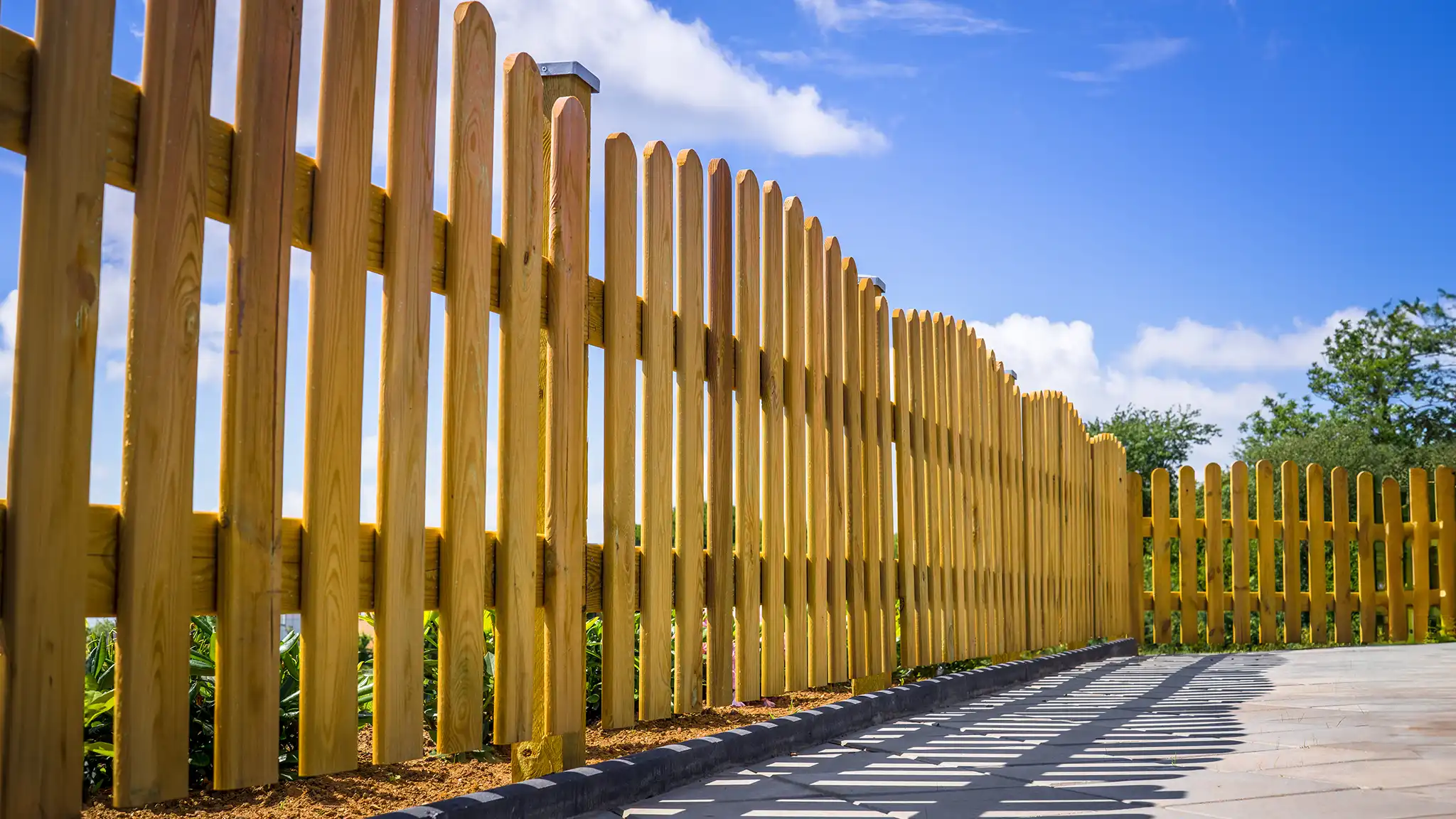 A Chowns Agricultural Services A wooden fence in Worcestershire with a blue sky.