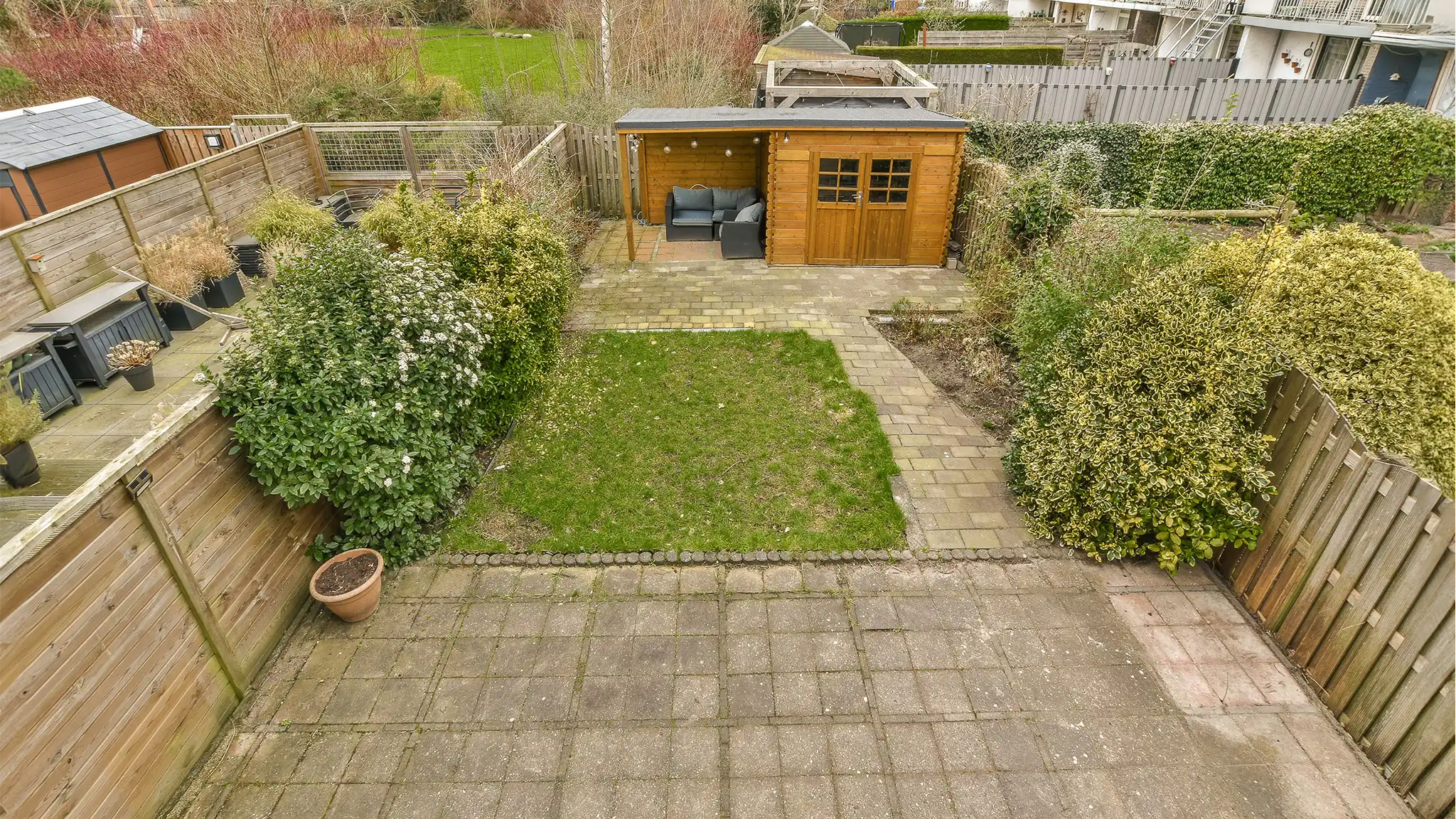 A Chowns Agricultural Services An aerial view of a backyard with a wooden shed located in Alcester, Warwickshire.