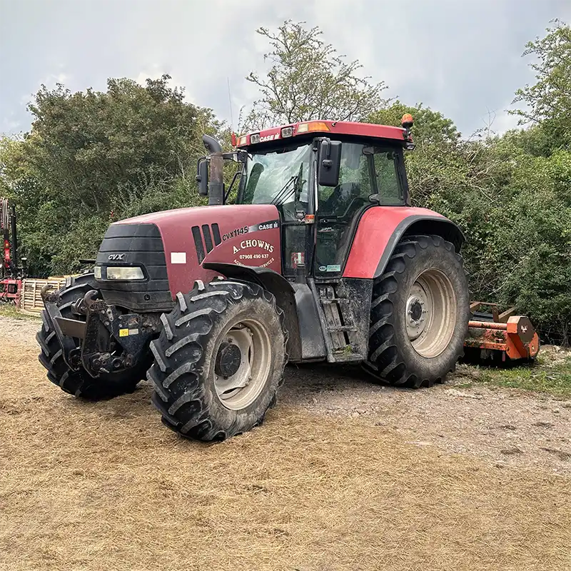 A Chowns Agricultural Services A red tractor parked in a field in Alcester, Warwickshire.