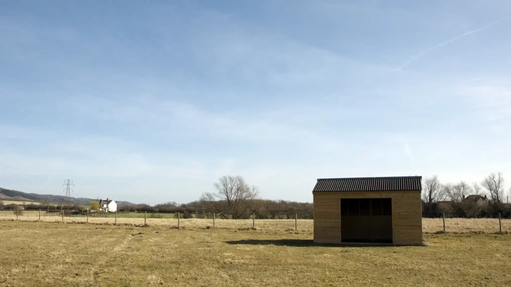 A Chowns Agricultural Services A small wooden shed sits in the middle of a farming field in Worcestershire.
