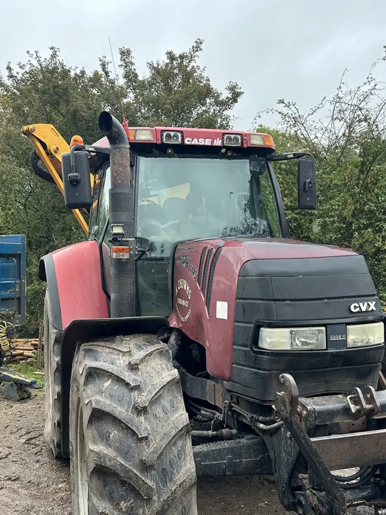 a-chowns-agricultural-services A red tractor is parked in the yard.