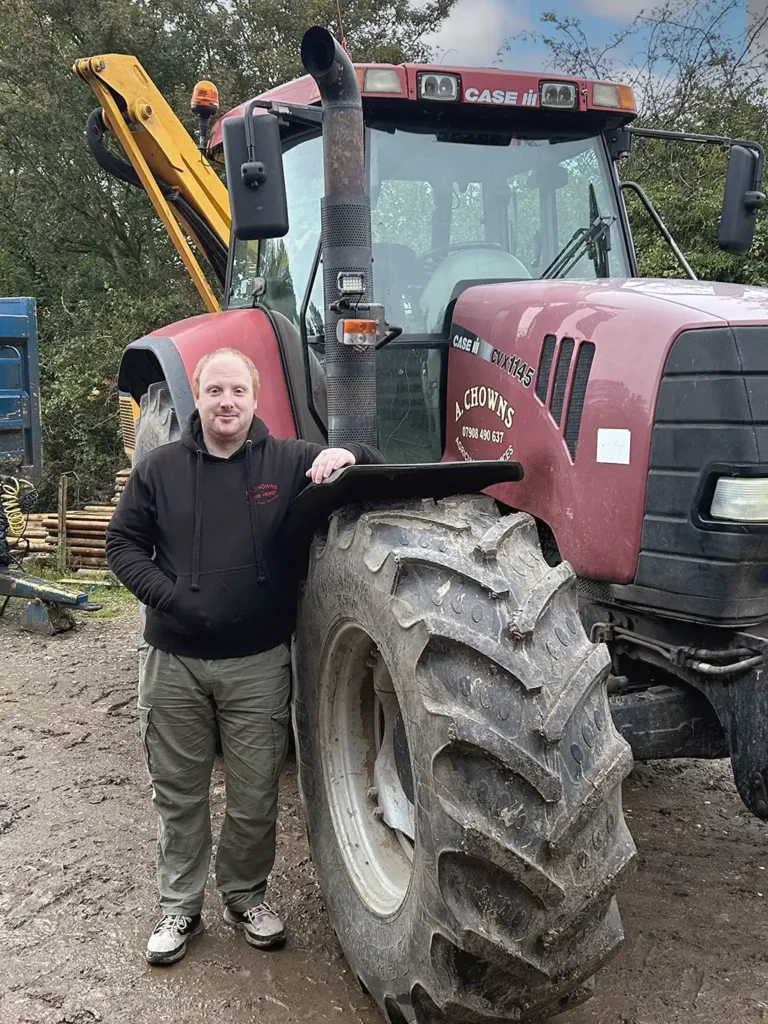 a-chowns-agricultural-services Richard Chowns standing next to a large tractor.